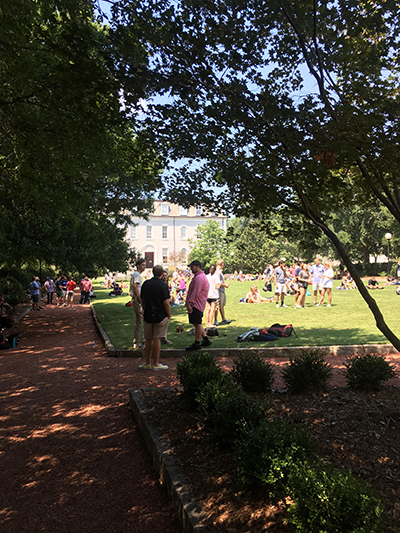 A small crowd gathers on Herty Field to watch the totality