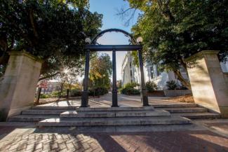 Image of the UGA Arch on North Campus with trees and buildings in background