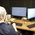 Dr. Chacón measures his brain data while viewing short sentences on a screen.